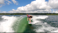 a woman wakesurfing on a sunny day on lake arenal
 - Costa Rica