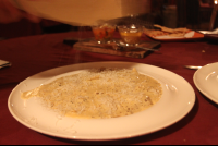 grating cheese on black truffle cream ravioli 
 - Costa Rica