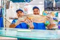 Vip City Tour Men Holding A Fish At Central Market
 - Costa Rica