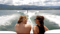 friends watching a third one waterskiing on lake arenal
 - Costa Rica