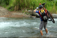 bamboo forest moutain bike tour crossing river 
 - Costa Rica